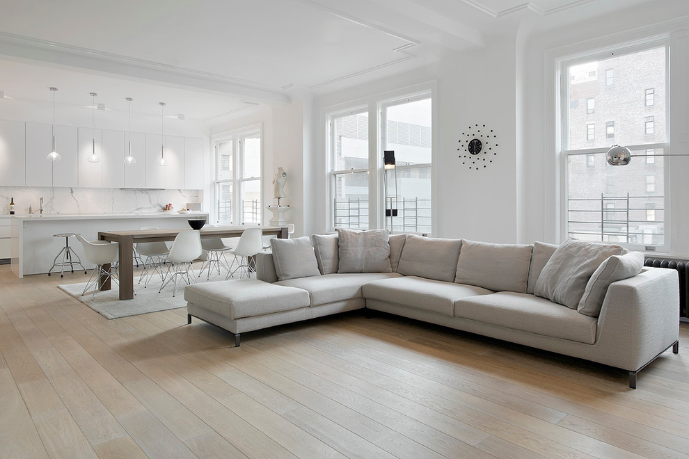 Design ideas for a scandinavian formal open concept living room in Other with white walls and light hardwood floors.