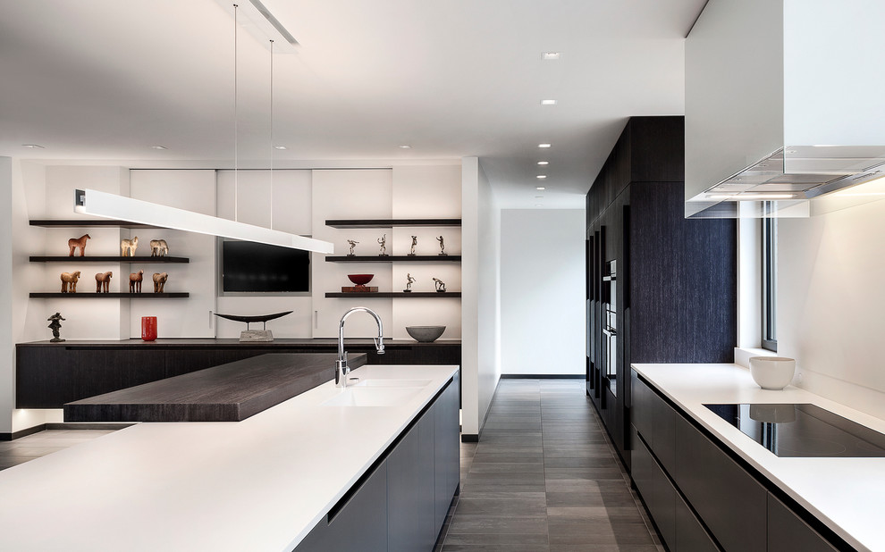 Contemporary kitchen in Denver with flat-panel cabinets, solid surface benchtops and with island.