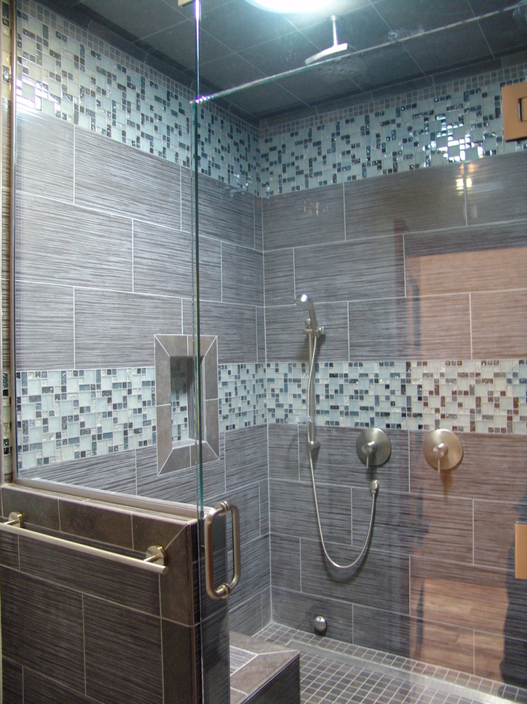 This is an example of a mid-sized traditional 3/4 bathroom in Other with shaker cabinets, medium wood cabinets, an alcove shower, a one-piece toilet, gray tile, porcelain tile, grey walls, porcelain floors, a vessel sink, tile benchtops, grey floor and a hinged shower door.