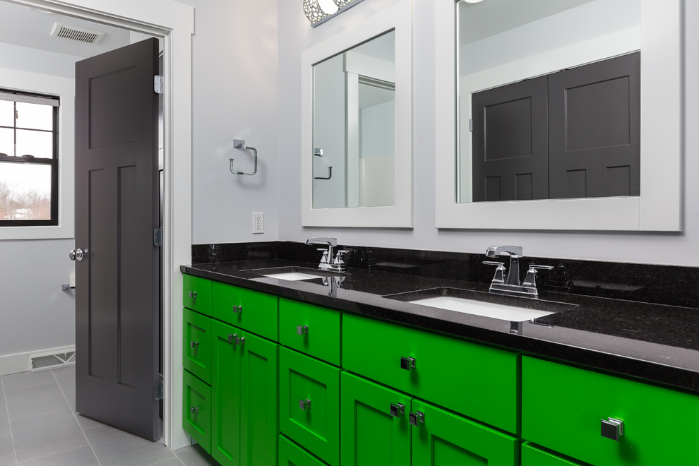 This is an example of a small contemporary master bathroom in Grand Rapids with green cabinets, grey walls, porcelain floors, an integrated sink and granite benchtops.