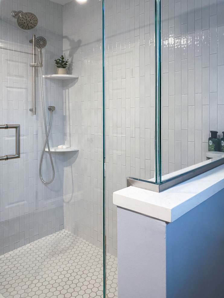Inspiration for a transitional white tile and ceramic tile porcelain tile, gray floor and single-sink corner shower remodel in Boston with shaker cabinets, gray cabinets, a one-piece toilet, gray walls, an undermount sink, quartz countertops, a hinged shower door, white countertops and a built-in vanity