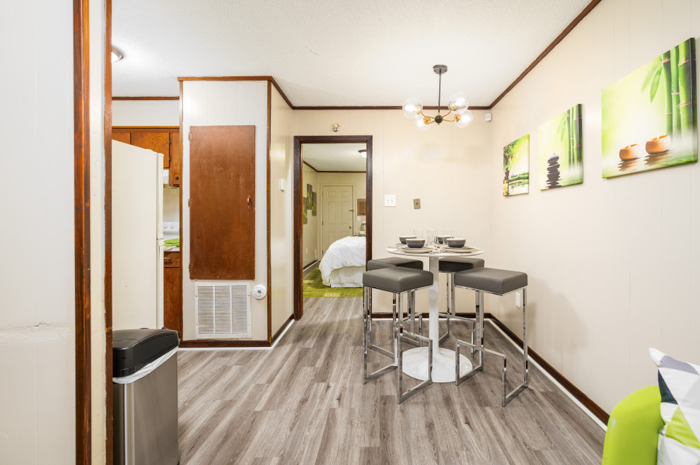 Inspiration pour une petite salle à manger minimaliste avec une banquette d'angle, un mur beige, un sol en vinyl et un sol gris.