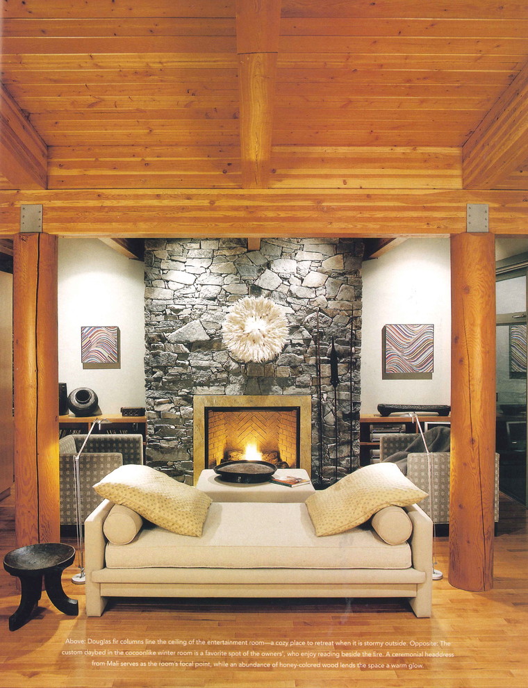 This is an example of a mid-sized contemporary open concept family room in Vancouver with white walls, medium hardwood floors, a standard fireplace, a stone fireplace surround, no tv and brown floor.