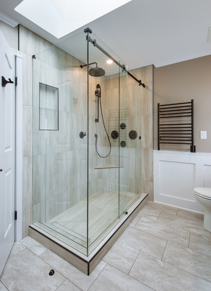 Photo of a large country master bathroom in Vancouver with shaker cabinets, dark wood cabinets, a freestanding tub, a corner shower, a two-piece toilet, gray tile, porcelain tile, grey walls, an undermount sink, glass benchtops, grey floor and a sliding shower screen.