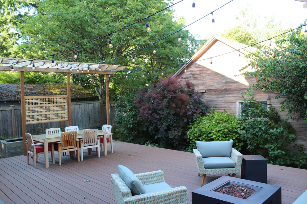 Photo of a mid-sized arts and crafts backyard deck in Seattle with a fire feature and no cover.