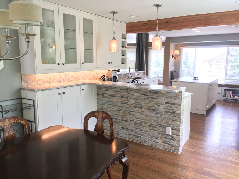Large transitional eat-in kitchen photo in Denver with a farmhouse sink, medium tone wood cabinets, stainless steel appliances and an island