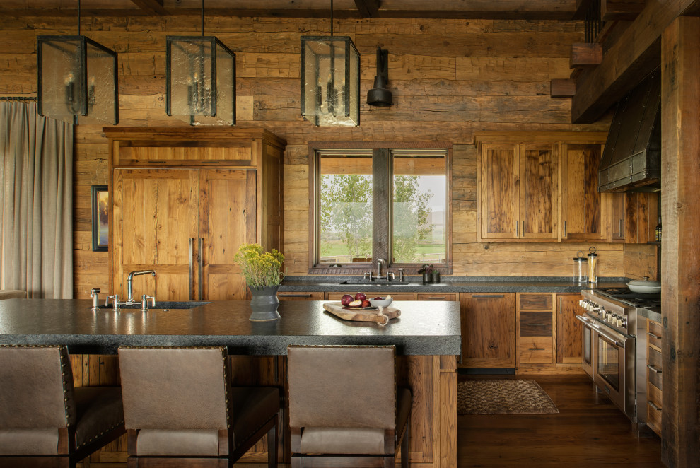 Large transitional l-shaped dark wood floor and exposed beam eat-in kitchen photo with an integrated sink, flat-panel cabinets, medium tone wood cabinets, wood backsplash, stainless steel appliances, an island and black countertops