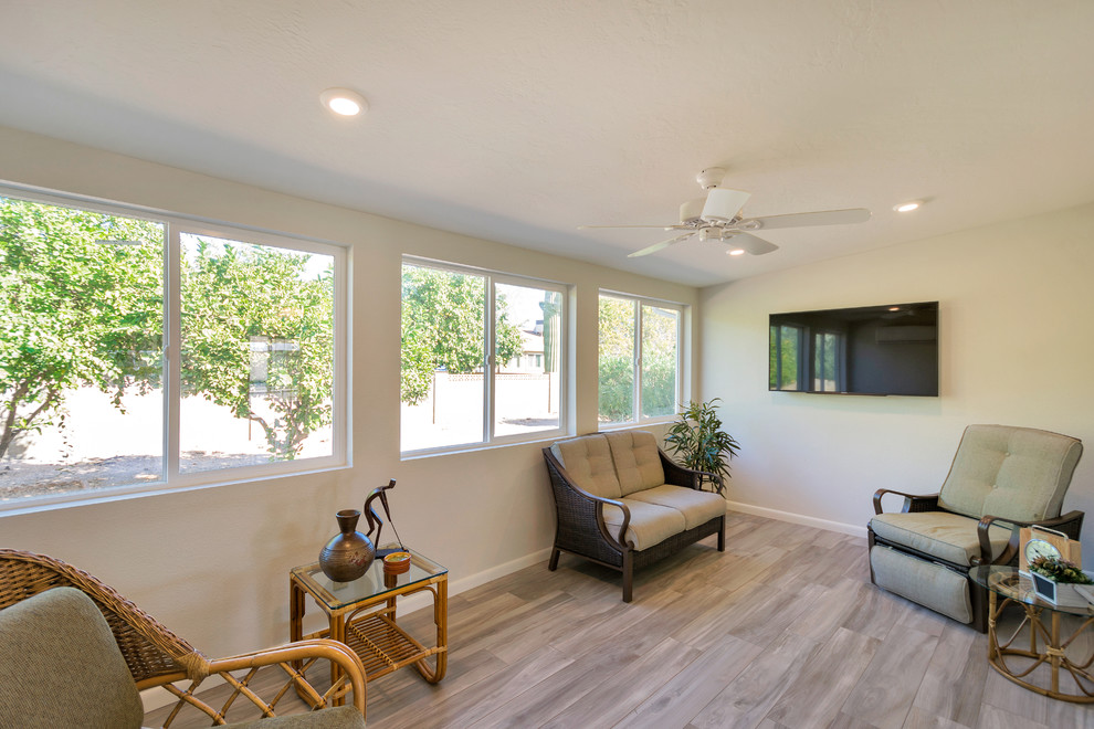 Open concept kitchen - large transitional l-shaped porcelain tile open concept kitchen idea in Phoenix with an undermount sink, raised-panel cabinets, white cabinets, quartz countertops, beige backsplash, porcelain backsplash, stainless steel appliances and an island