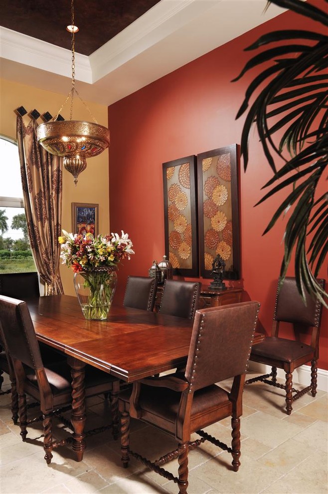 Design ideas for a mediterranean dining room in Miami with red walls.