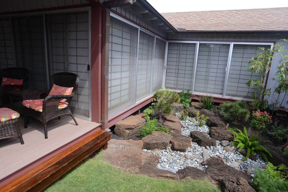 Inspiration for a mid-sized asian side yard partial sun formal garden for summer in Hawaii with concrete pavers and a water feature.