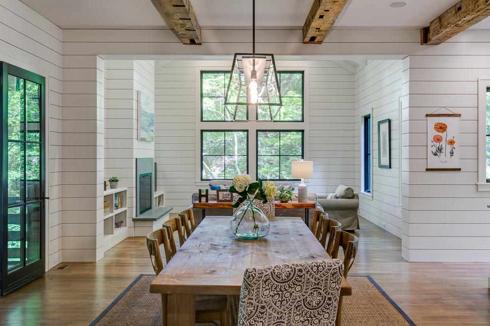 Country dining room in Other with white walls, medium hardwood floors and brown floor.