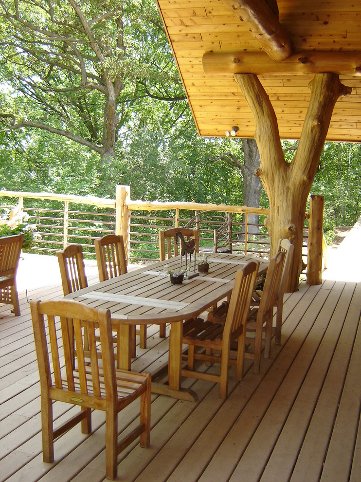 Inspiration for a country deck in Minneapolis with a roof extension.