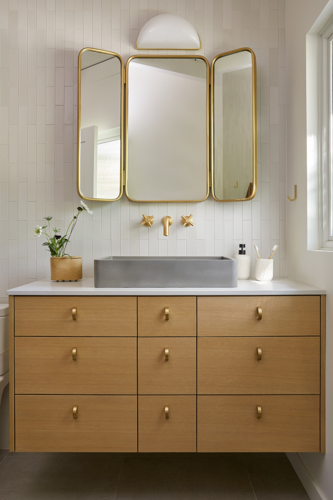 Photo of a small midcentury master bathroom in San Francisco with flat-panel cabinets, light wood cabinets, an open shower, a one-piece toilet, white tile, ceramic tile, white walls, porcelain floors, a vessel sink, engineered quartz benchtops, grey floor, an open shower, grey benchtops, a single vanity, a floating vanity and exposed beam.
