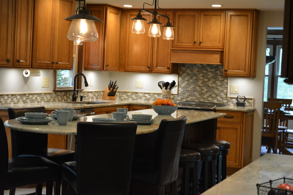 Kitchen - large eclectic dark wood floor kitchen idea with an undermount sink, raised-panel cabinets, medium tone wood cabinets, granite countertops, mosaic tile backsplash, stainless steel appliances and an island