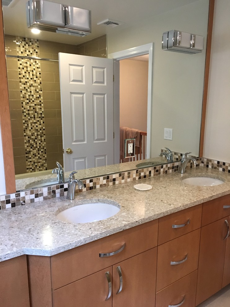 This is an example of a transitional master bathroom in Boston with flat-panel cabinets, light wood cabinets, an alcove tub, a shower/bathtub combo, brown tile, subway tile, beige walls, light hardwood floors, an undermount sink and granite benchtops.