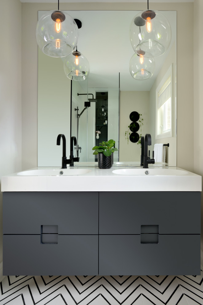 This is an example of a small modern master bathroom in Toronto with flat-panel cabinets, black cabinets, a curbless shower, a one-piece toilet, black and white tile, ceramic tile, beige walls, ceramic floors, an integrated sink, solid surface benchtops, white floor, a hinged shower door, white benchtops, a niche, a double vanity and a floating vanity.