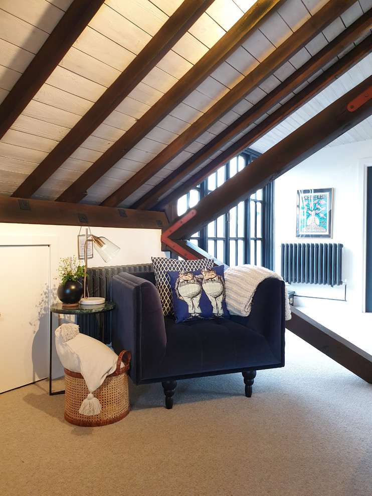 Inspiration for a small industrial bedroom in London with carpet.