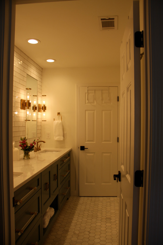 Photo of a medium sized traditional grey and white family bathroom in Atlanta with recessed-panel cabinets, green cabinets, a freestanding bath, a shower/bath combination, a two-piece toilet, white tiles, ceramic tiles, white walls, marble flooring, a submerged sink, engineered stone worktops, white floors, a hinged door, white worktops, double sinks and a built in vanity unit.