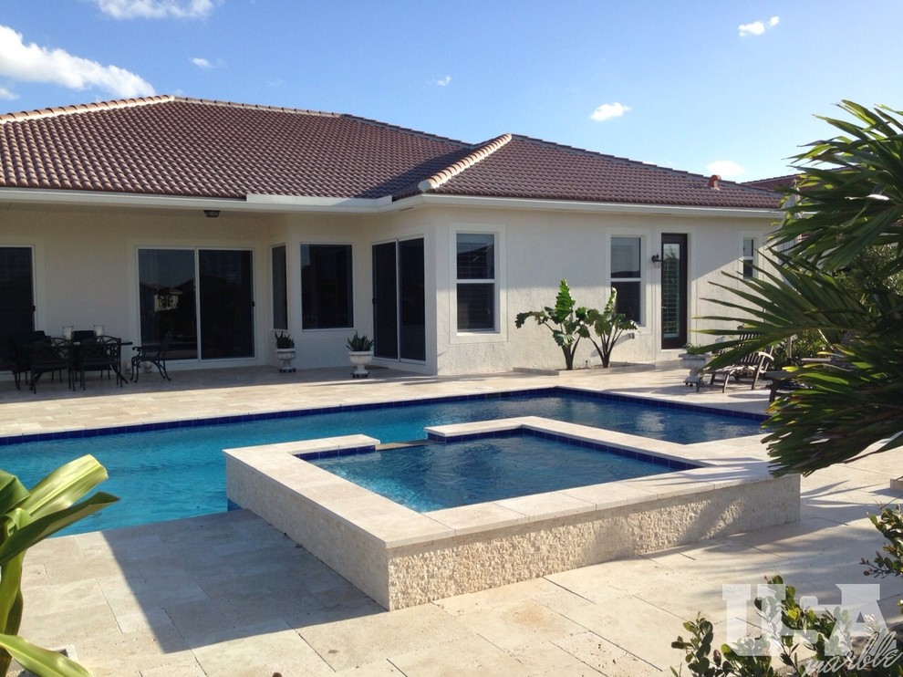 Large country aboveground pool in Miami with natural stone pavers.