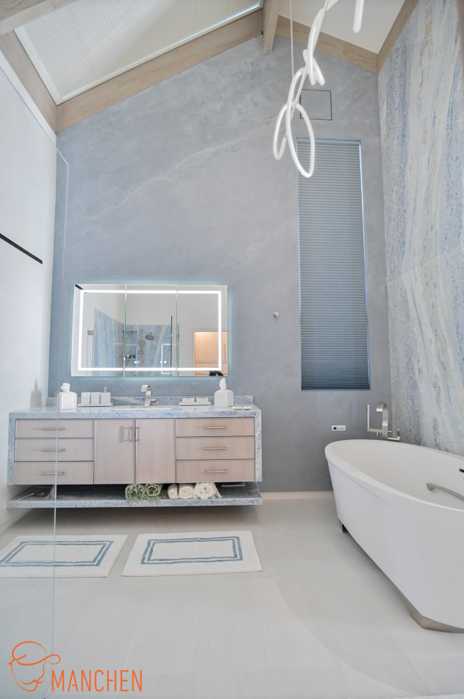 Inspiration for a large coastal ensuite wet room bathroom in Los Angeles with freestanding cabinets, light wood cabinets, a freestanding bath, blue tiles, stone slabs, blue walls, porcelain flooring, a submerged sink, quartz worktops, beige floors, an open shower, blue worktops, a single sink, a floating vanity unit and a vaulted ceiling.