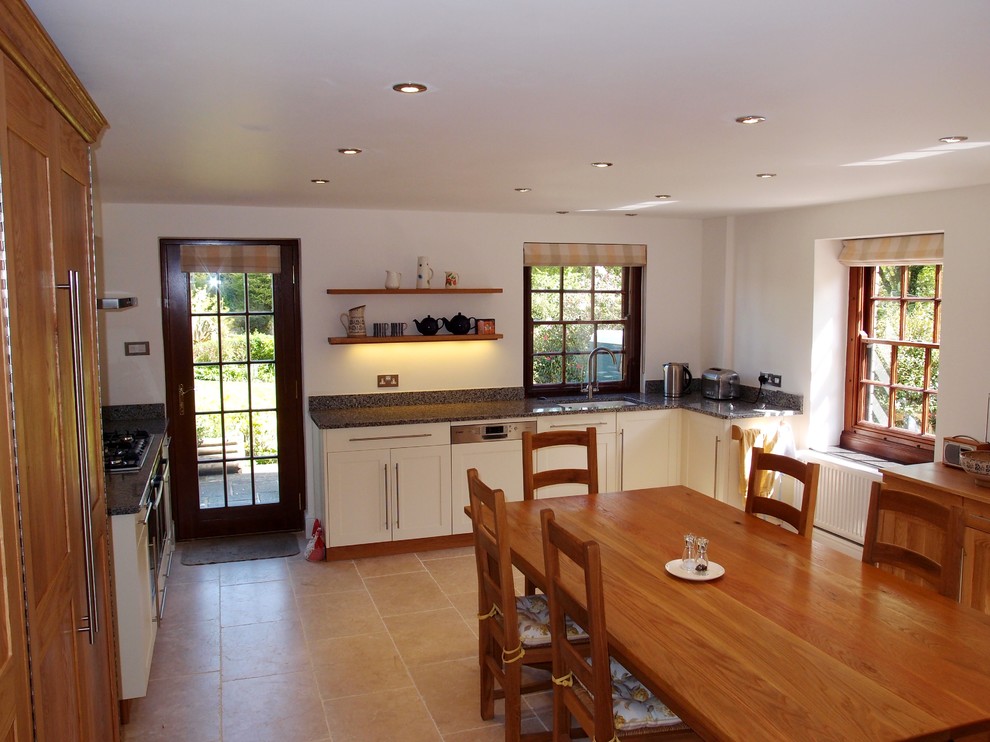 Inspiration for a large country l-shaped kitchen in Cornwall with shaker cabinets, white cabinets and granite benchtops.