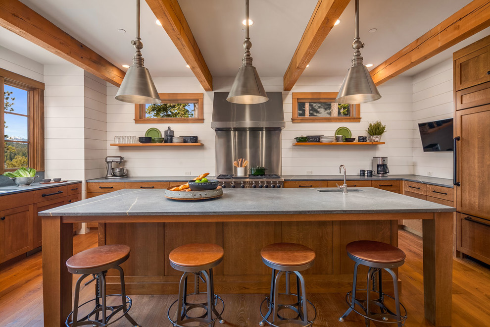 Inspiration for a mid-sized traditional u-shaped eat-in kitchen in Seattle with an undermount sink, flat-panel cabinets, medium wood cabinets, granite benchtops, white splashback, stainless steel appliances, medium hardwood floors and with island.
