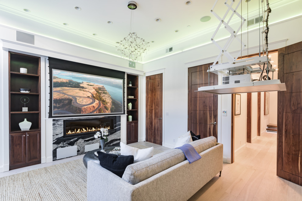 Large modern enclosed home theatre in San Francisco with white walls, light hardwood floors, a projector screen and beige floor.