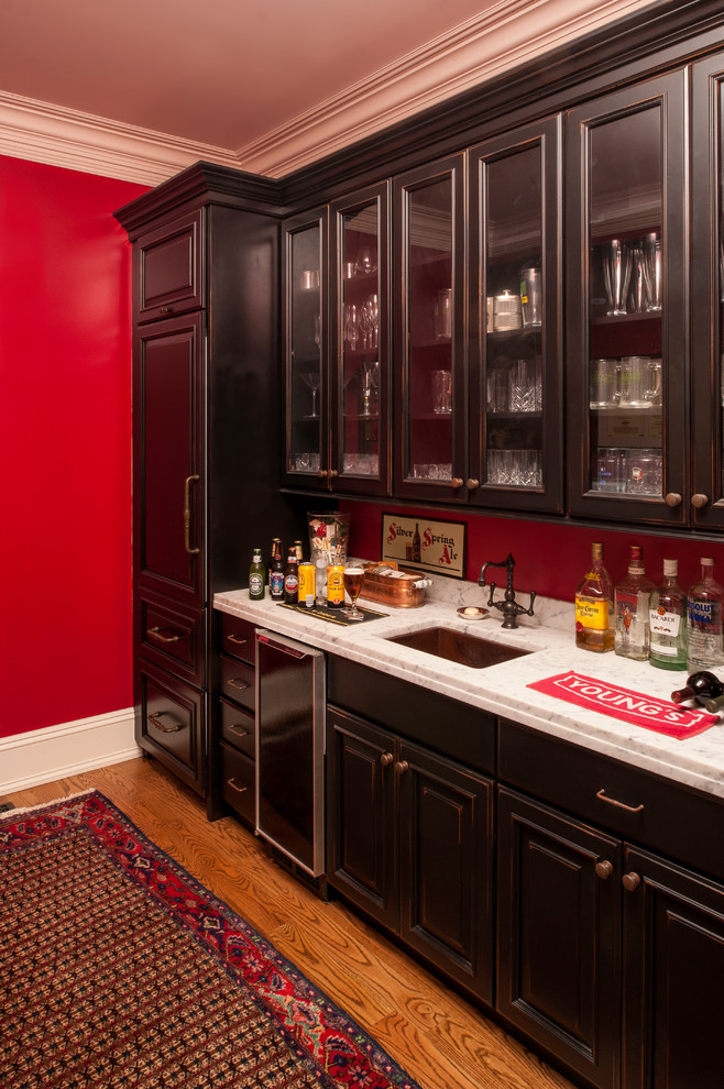 Photo of a mid-sized traditional wine cellar in Chicago with dark hardwood floors and display racks.