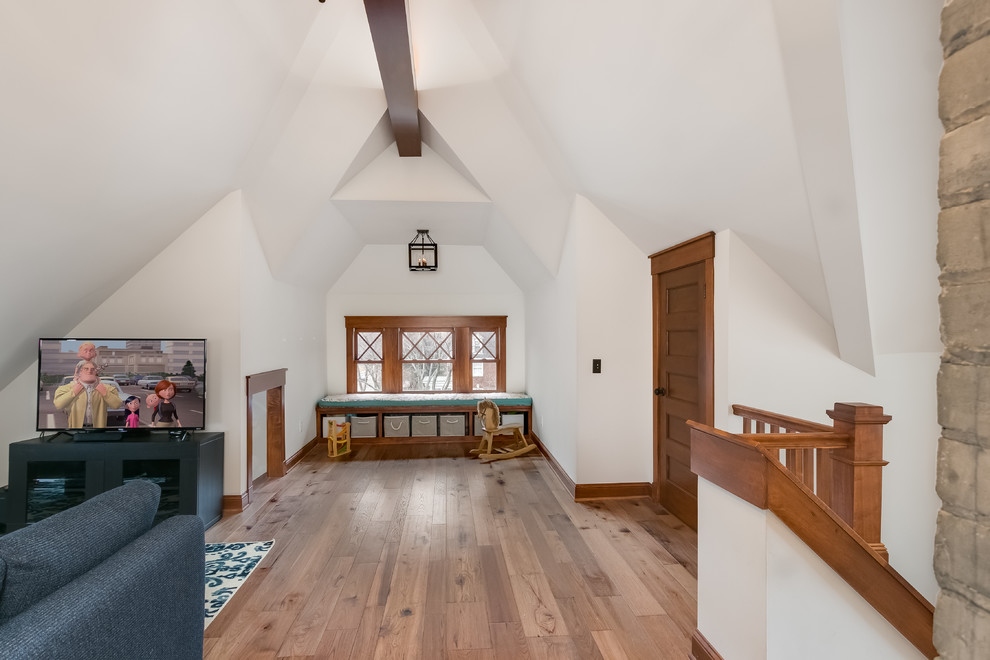 Photo of a large contemporary loft-style family room in Minneapolis with a home bar, white walls, light hardwood floors, no fireplace, a freestanding tv and beige floor.
