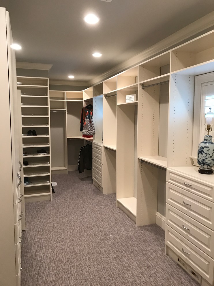 Design ideas for a large traditional gender-neutral walk-in wardrobe in Huntington with raised-panel cabinets, white cabinets, carpet and grey floor.