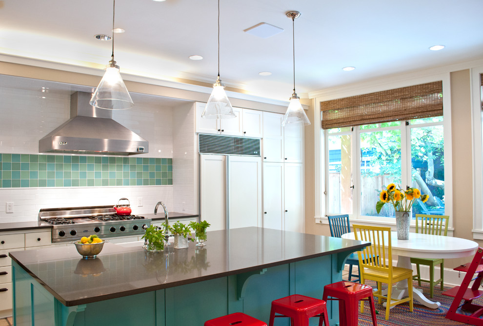 Large modern u-shaped eat-in kitchen in Seattle with a farmhouse sink, raised-panel cabinets, white cabinets, solid surface benchtops, white splashback, subway tile splashback, stainless steel appliances, terra-cotta floors, with island and beige floor.