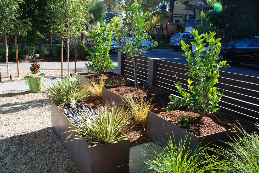 Inspiration for a contemporary partial sun garden in San Francisco with a water feature and concrete pavers.