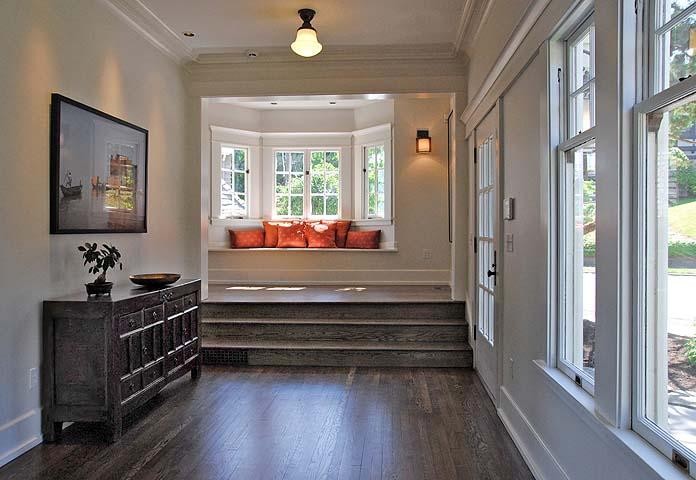 Inspiration for a large timeless medium tone wood floor hallway remodel in Chicago with white walls