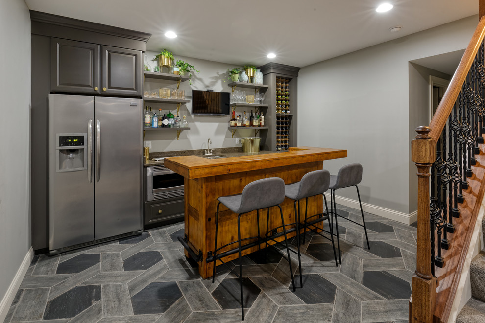 Design ideas for a transitional basement in Cincinnati with grey walls, porcelain floors and grey floor.