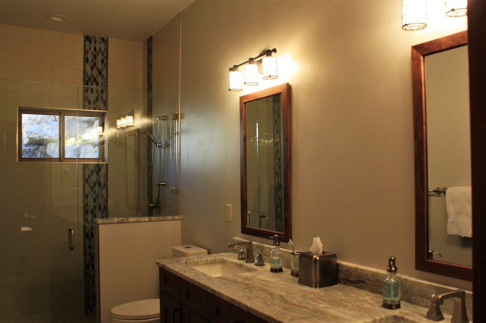 Example of a large mountain style master brown floor bathroom design with an undermount tub and quartz countertops