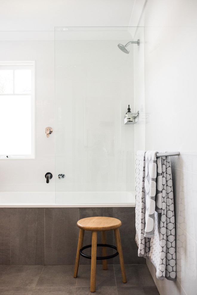 Small contemporary bathroom in Perth with a shower/bathtub combo, white tile, ceramic tile, white walls, ceramic floors, an undermount sink, solid surface benchtops and grey floor.