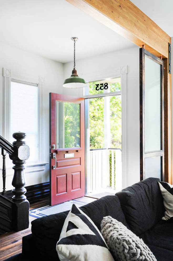 This is an example of a mid-sized eclectic entryway in Vancouver with white walls, a single front door and a red front door.