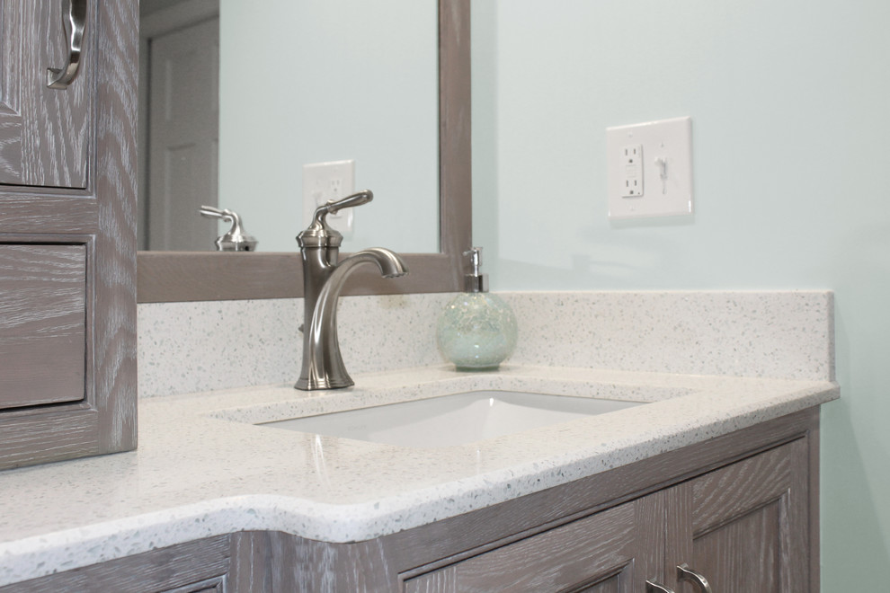 Inspiration for a mid-sized transitional master white tile and ceramic tile ceramic tile and gray floor alcove shower remodel in Boston with shaker cabinets, distressed cabinets, a two-piece toilet, blue walls, an undermount sink, quartz countertops and white countertops