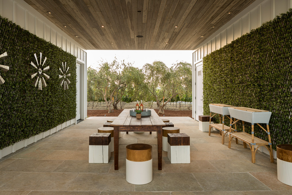 Country courtyard patio in San Francisco with a vertical garden, tile and a roof extension.
