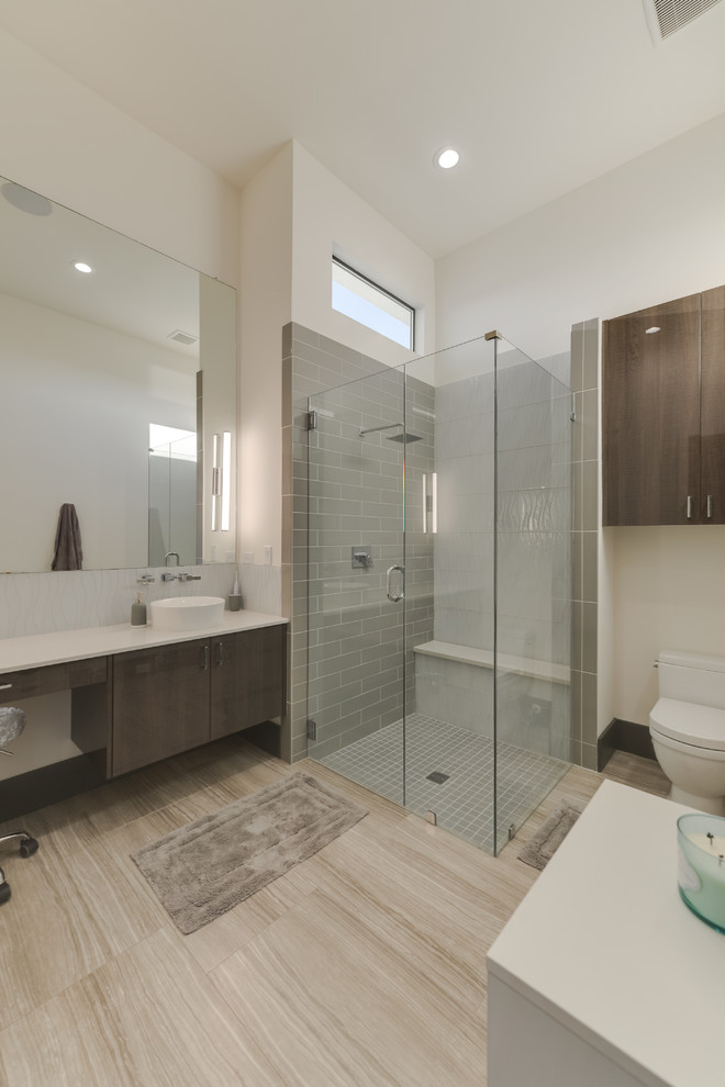 Design ideas for a mid-sized modern master bathroom in Austin with glass-front cabinets, medium wood cabinets, a freestanding tub, an open shower, a one-piece toilet, brown tile, marble, white walls, porcelain floors, a vessel sink, marble benchtops, brown floor, an open shower and multi-coloured benchtops.
