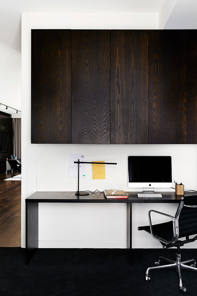 Contemporary study room in Melbourne with white walls, carpet and a freestanding desk.