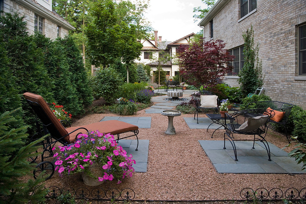 Photo of a small transitional side yard patio in Chicago with decomposed granite and no cover.