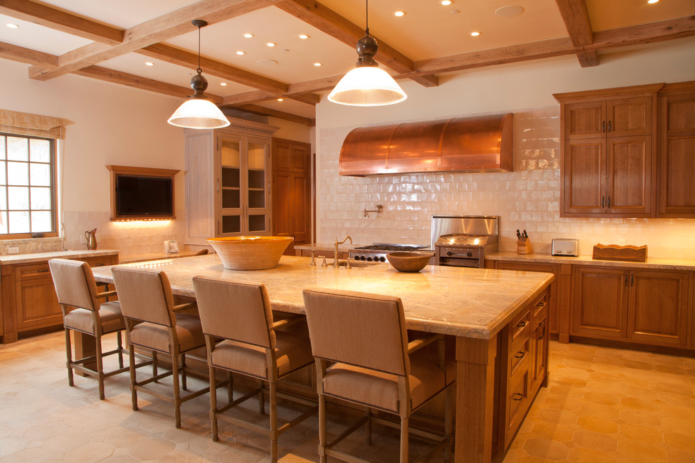 Kitchen - limestone floor kitchen idea with granite countertops, paneled appliances and an island