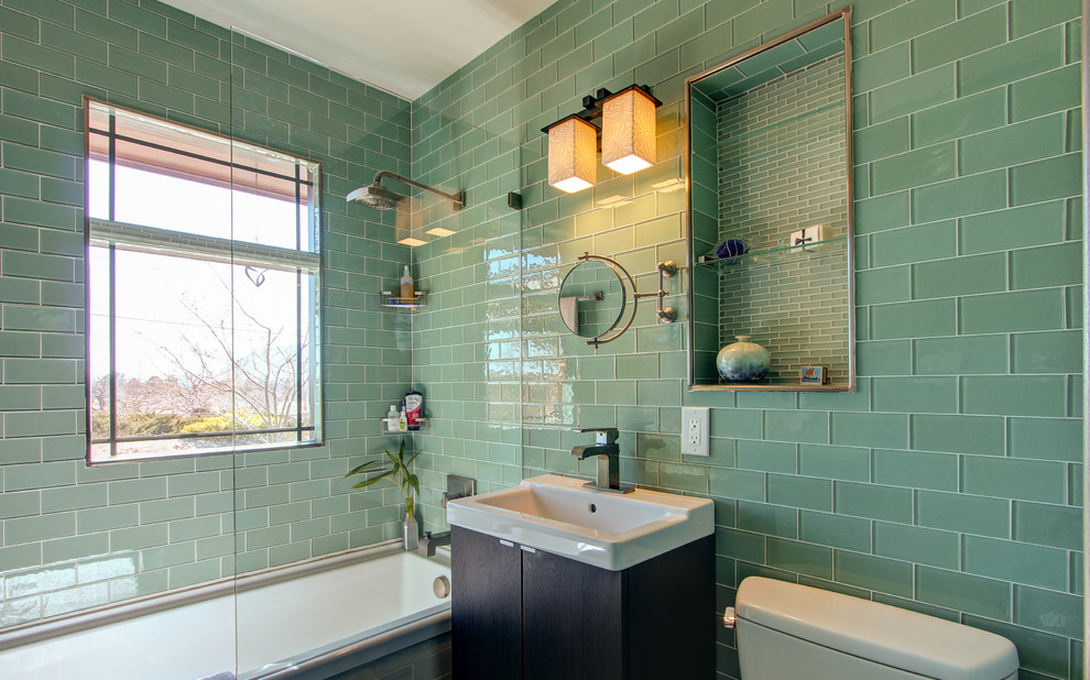 Example of a transitional green tile and glass tile alcove bathtub design in Denver with a console sink