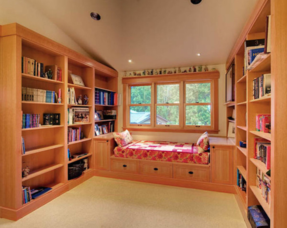 This is an example of a country enclosed family room in Seattle with a library, beige walls and carpet.