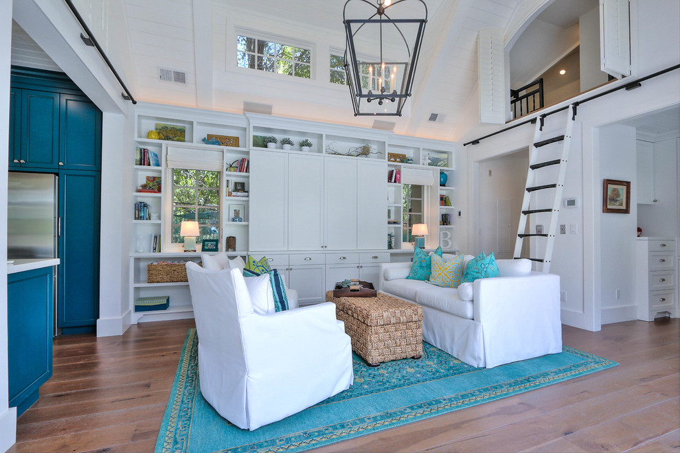 This is an example of a mid-sized beach style enclosed family room in San Francisco with white walls and light hardwood floors.