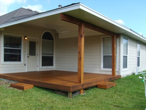 This is an example of a small traditional backyard patio in Austin with decking and a roof extension.