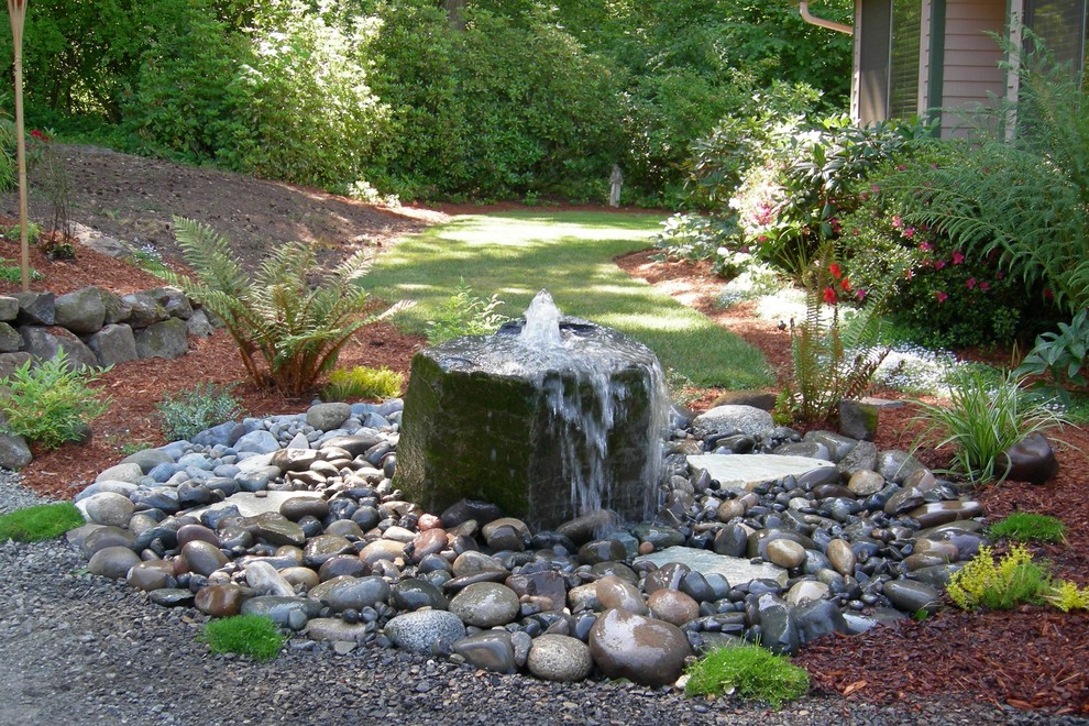 Mid-sized contemporary backyard partial sun formal garden in Seattle with a water feature and gravel.