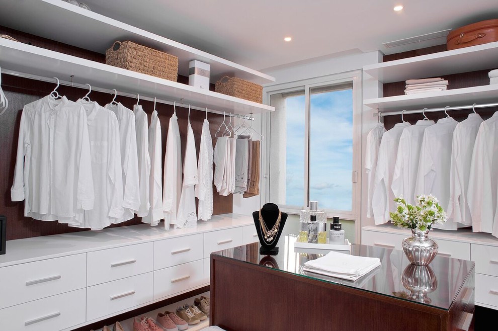 Mid-sized contemporary gender-neutral walk-in wardrobe in Other with open cabinets, white cabinets, marble floors and beige floor.