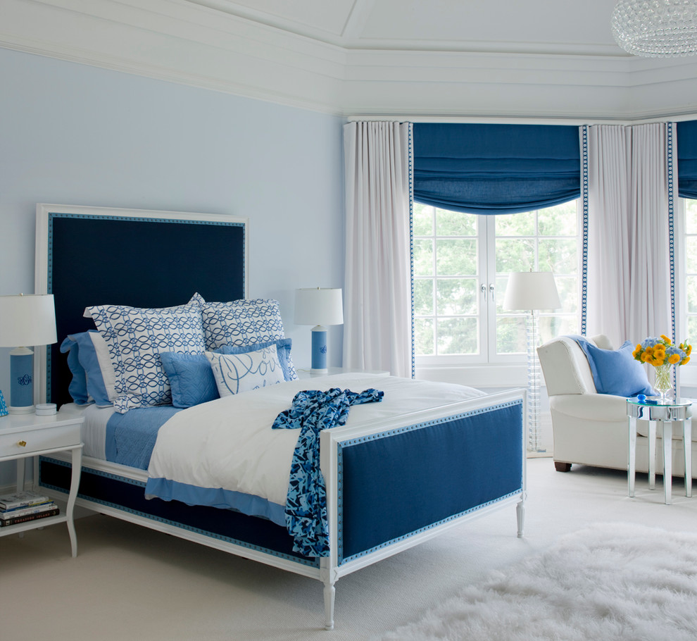 Photo of a traditional bedroom in Miami with blue walls, carpet and beige floor.